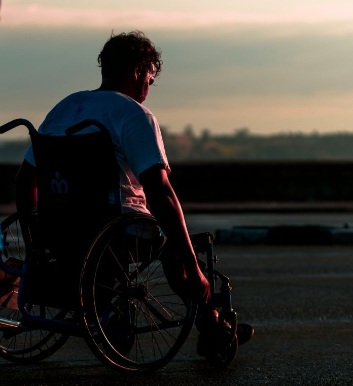 man riding on wheelchair during daytime